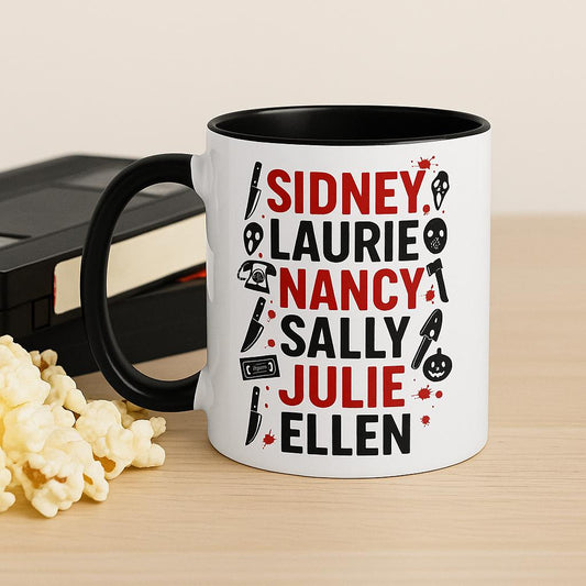 White ceramic mug with black handle and interior featuring Final Girls slasher movie design, styled with popcorn and VHS tapes for a retro spooky movie vibe.