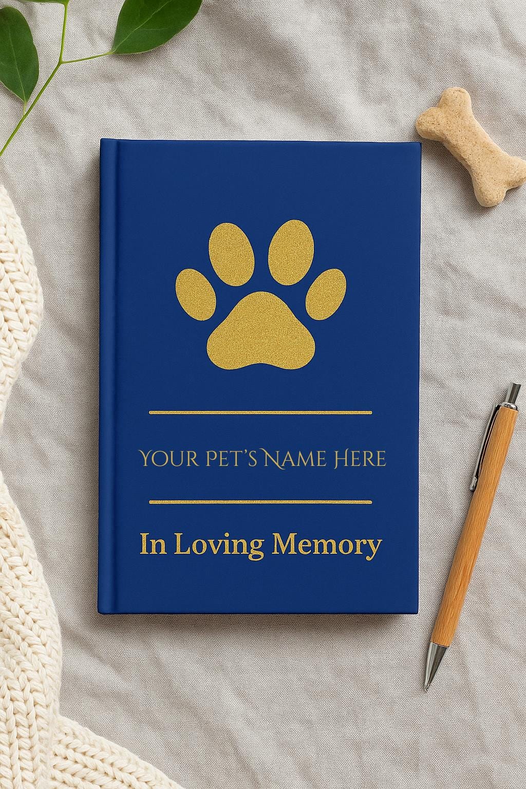 Close-up of gold paw print and In Loving Memory text on navy blue hardcover journal, personalized with pet’s name, high-quality matte finish.